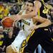 Michigan freshman Mitch McGary moves the ball by Iowa freshman Adam Woodbury during the first half against Iowa at Crisler Center on Sunday, Jan. 6. Michigan beat Iowa 95-67 in the Big Ten home opener. Melanie Maxwell I AnnArbor.com